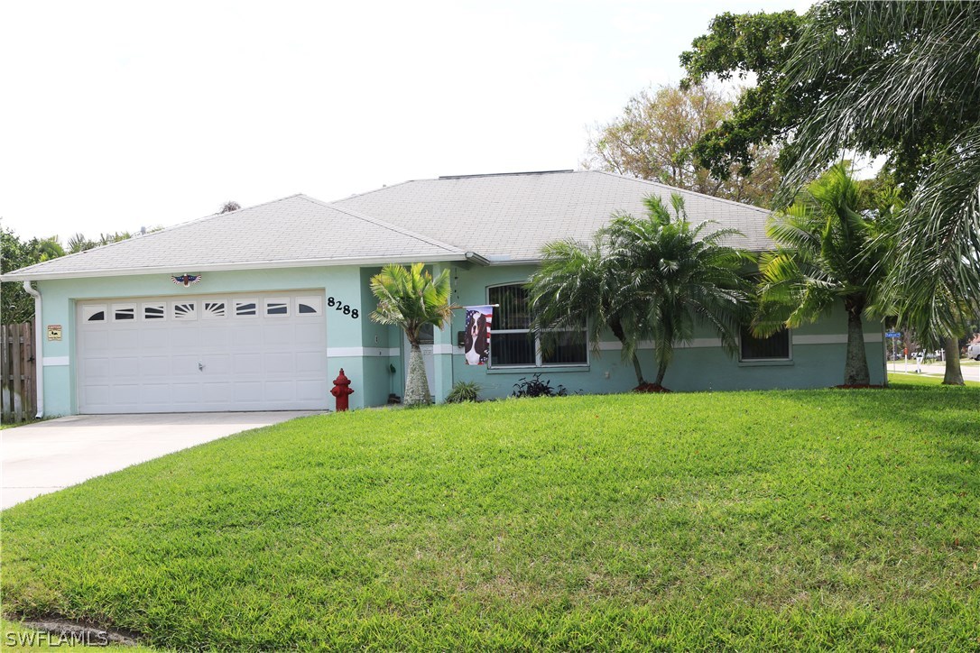 8288 Bahamas Road Fort Myers, FL 33967 - Photo 1 of 23 a view of a house with a yard and a large tree