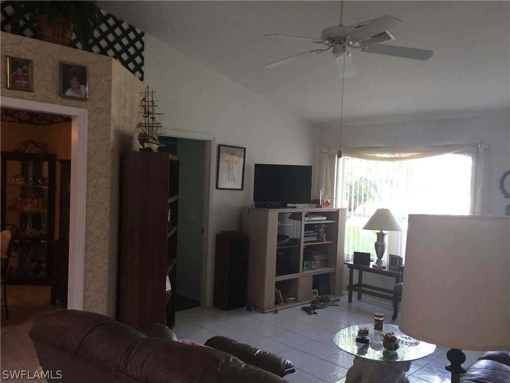 8288 Bahamas Road Fort Myers, FL 33967 - Photo 11 of 23 a living room with furniture and a flat screen tv