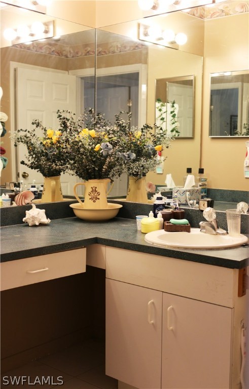 8288 Bahamas Road Fort Myers, FL 33967 - Photo 17 of 23 a kitchen with a sink and large mirror