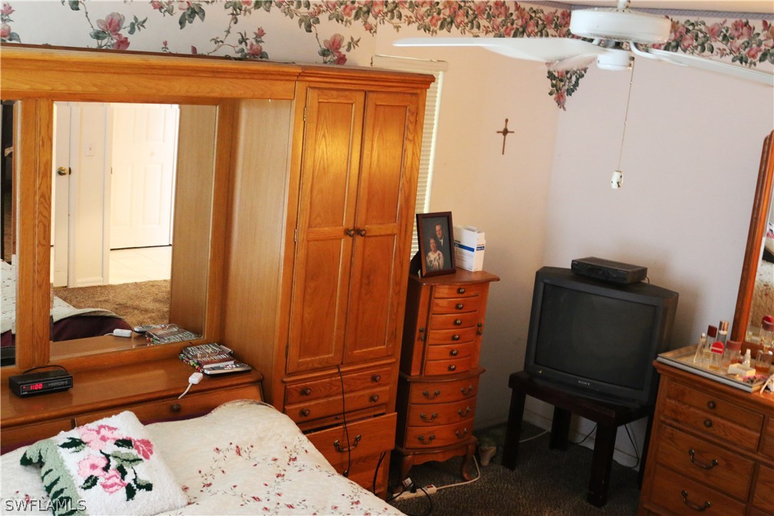 8288 Bahamas Road Fort Myers, FL 33967 - Photo 18 of 23 a bedroom with a bed and wooden floor