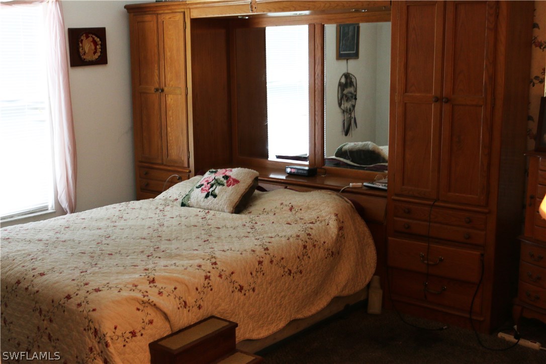 8288 Bahamas Road Fort Myers, FL 33967 - Photo 19 of 23 a bedroom with a bed and a window
