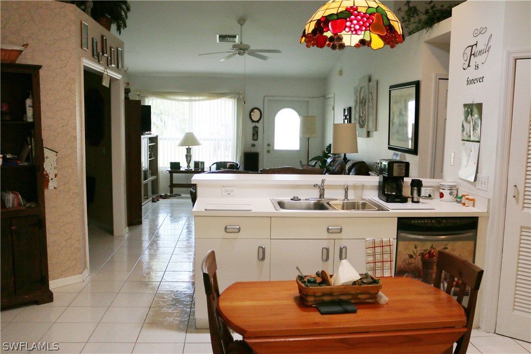 8288 Bahamas Road Fort Myers, FL 33967 - Photo 5 of 23 a room with stainless steel appliances kitchen island a table and chairs in it