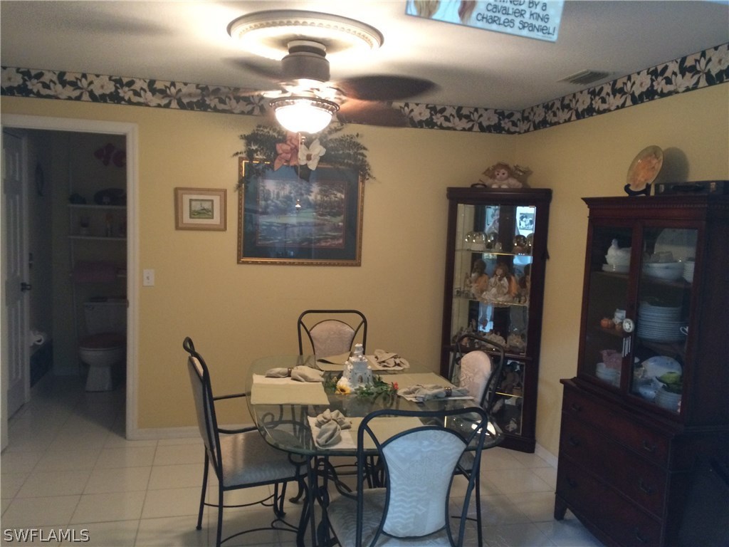 8288 Bahamas Road Fort Myers, FL 33967 - Photo 8 of 23 a view of a dining room with furniture and chandelier