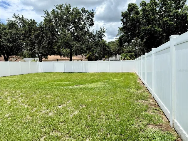 a view of yard with large trees