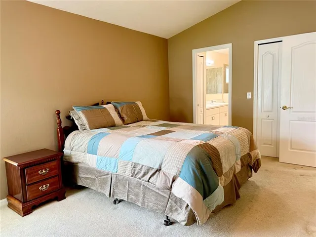 a spacious bedroom with a bed and a window