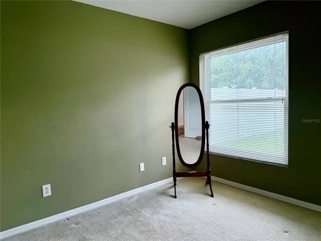 a bench sitting in a room next to a window