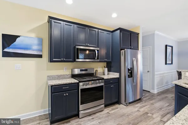 a large kitchen with a table and chairs