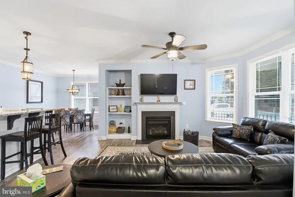 a kitchen with granite countertop wooden cabinets a center island and stainless steel appliances