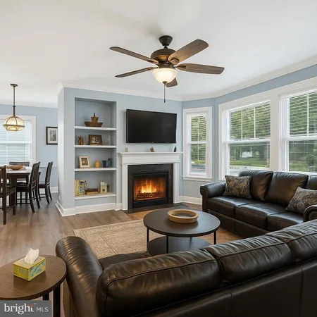 a living room with furniture fireplace and flat screen tv