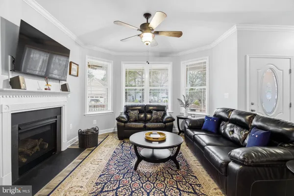 a living room with furniture fireplace and a flat screen tv