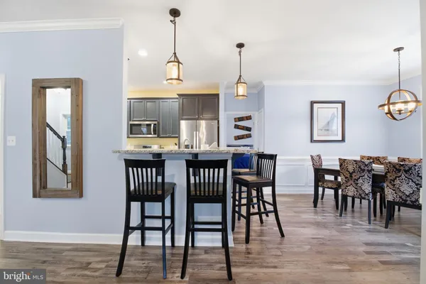 a living room with furniture a fireplace and a large window