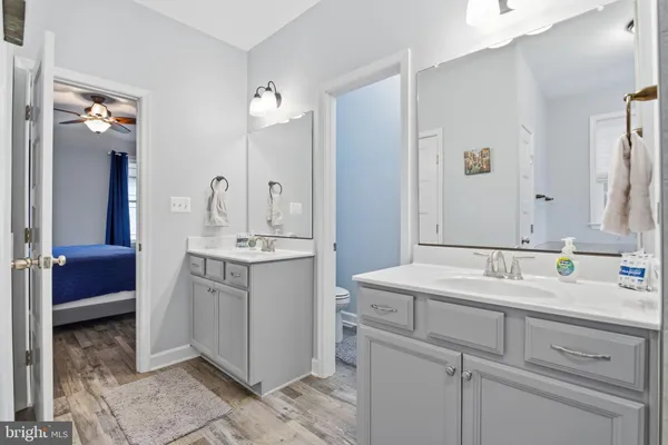 a bedroom with a large bed and wooden floor
