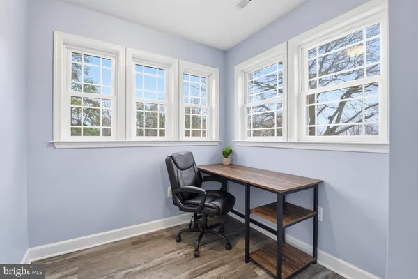 a view of kids room with toys and wooden floor