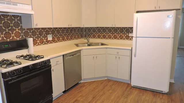 a kitchen with a sink stove and refrigerator