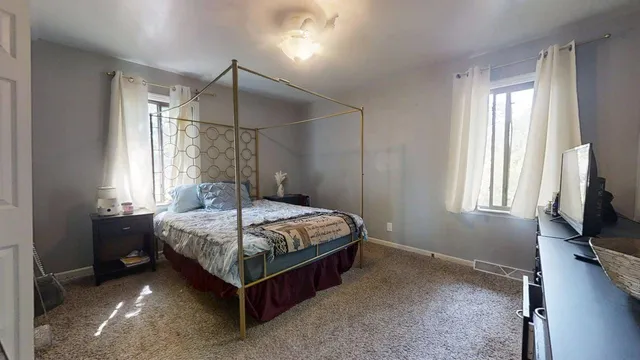 a bedroom with a bed and a dresser