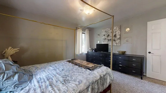 a bedroom with a bed and a dresser