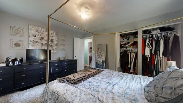 a bedroom with a bed and a dresser