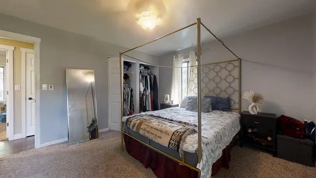 a bedroom with furniture and a window