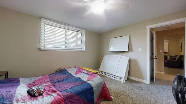 a bedroom with bed and a chandelier