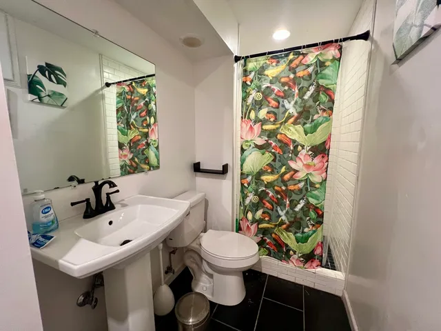 a view of a roof deck with couches and wooden floor