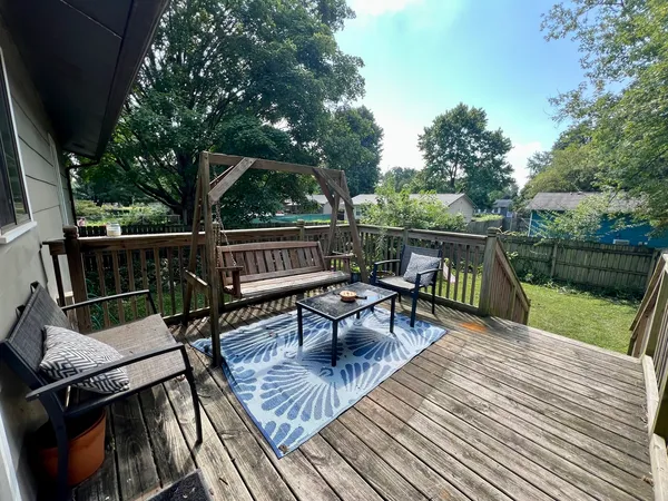 a roof deck with a table and chairs