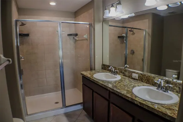 a bedroom with a bed and painting on the wall