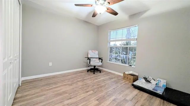 a bathroom with a granite countertop bathtub sink vanity mirror and toilet