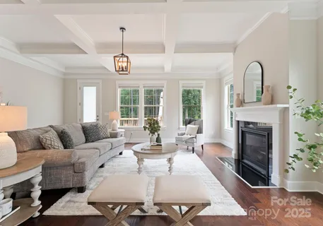 a living room with furniture a fireplace and a table