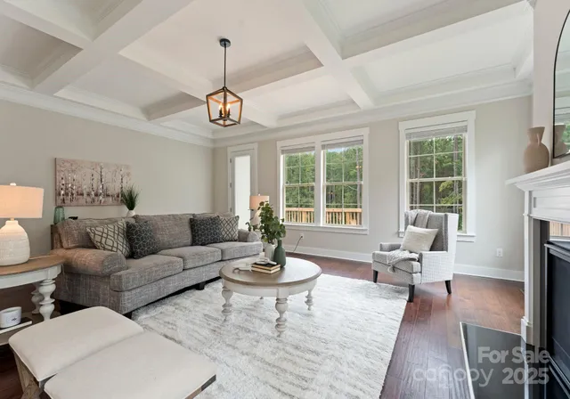 a living room with fireplace furniture and a large window