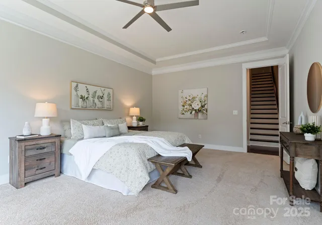 a spacious bedroom with a bed a couch and a window