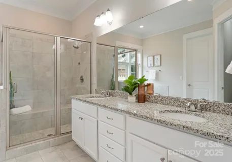 a bathroom with a granite countertop sink a shower and a mirror