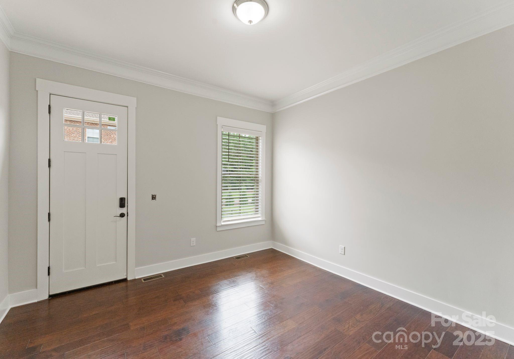 676 Kenway Loop Mooresville, NC 28117 - Photo 25 of 40 an empty room with wooden floor and windows