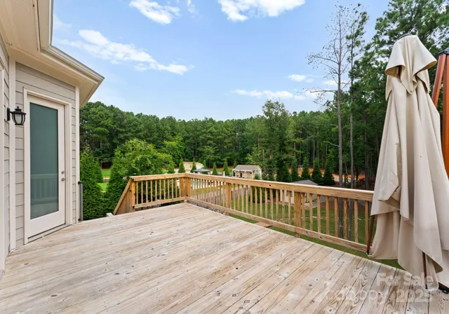 a balcony with wooden floor and fence