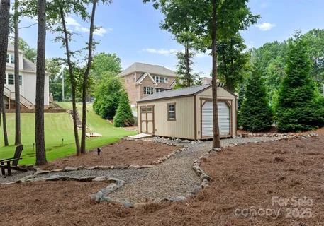 a view of a house with a backyard and a tree