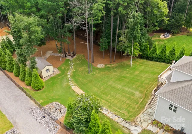 an aerial view of a house with pool