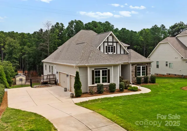 a front view of a house with a yard garden