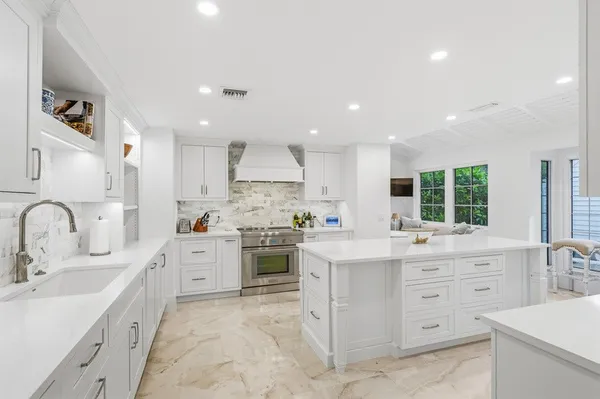 a kitchen with a sink stove and cabinets