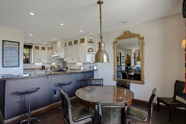 a kitchen with cabinets appliances a sink and a window