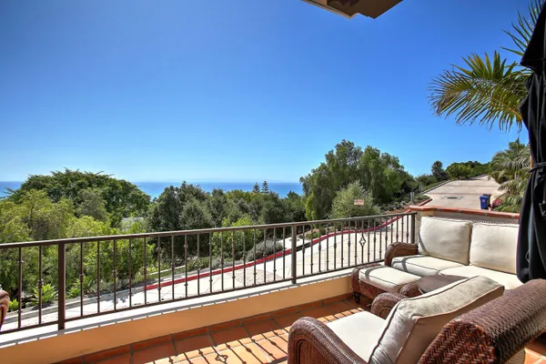 a view of balcony with furniture