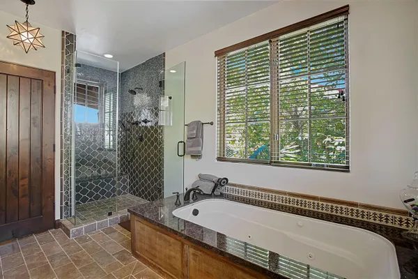 a kitchen with granite countertop white cabinets and a sink