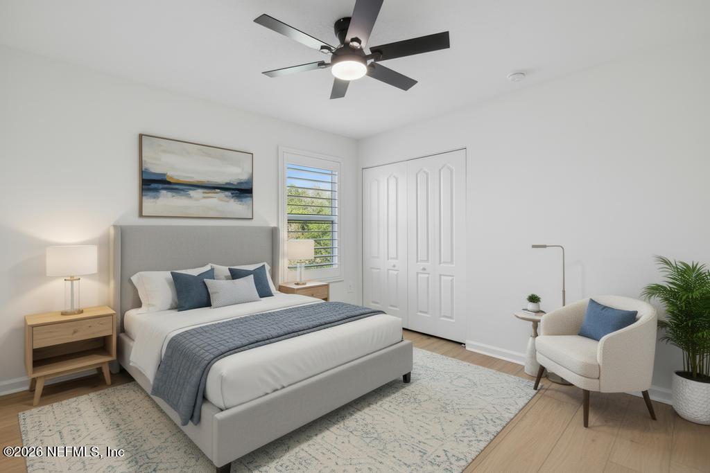 45 Seaport Breeze Road St. Augustine, FL 32095 - Photo 44 of 88 a bedroom with a bed and a chandelier