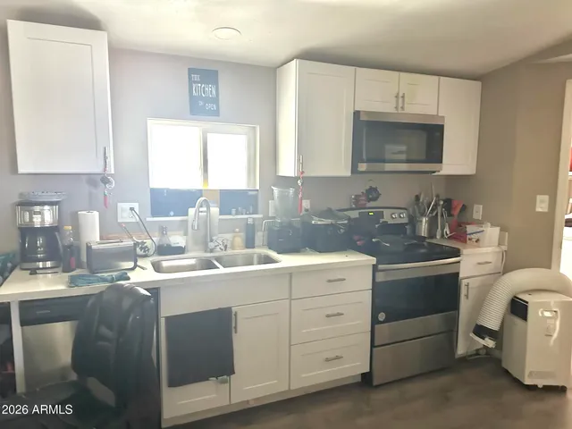a kitchen with a sink stove and cabinets