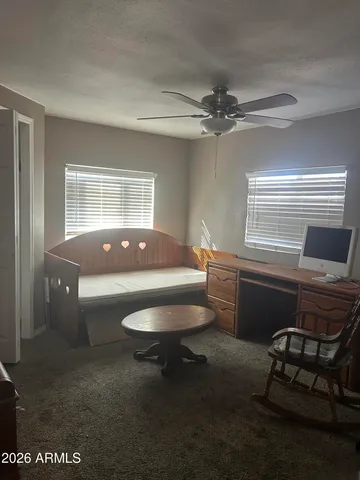 a living room with furniture a chandelier and a window