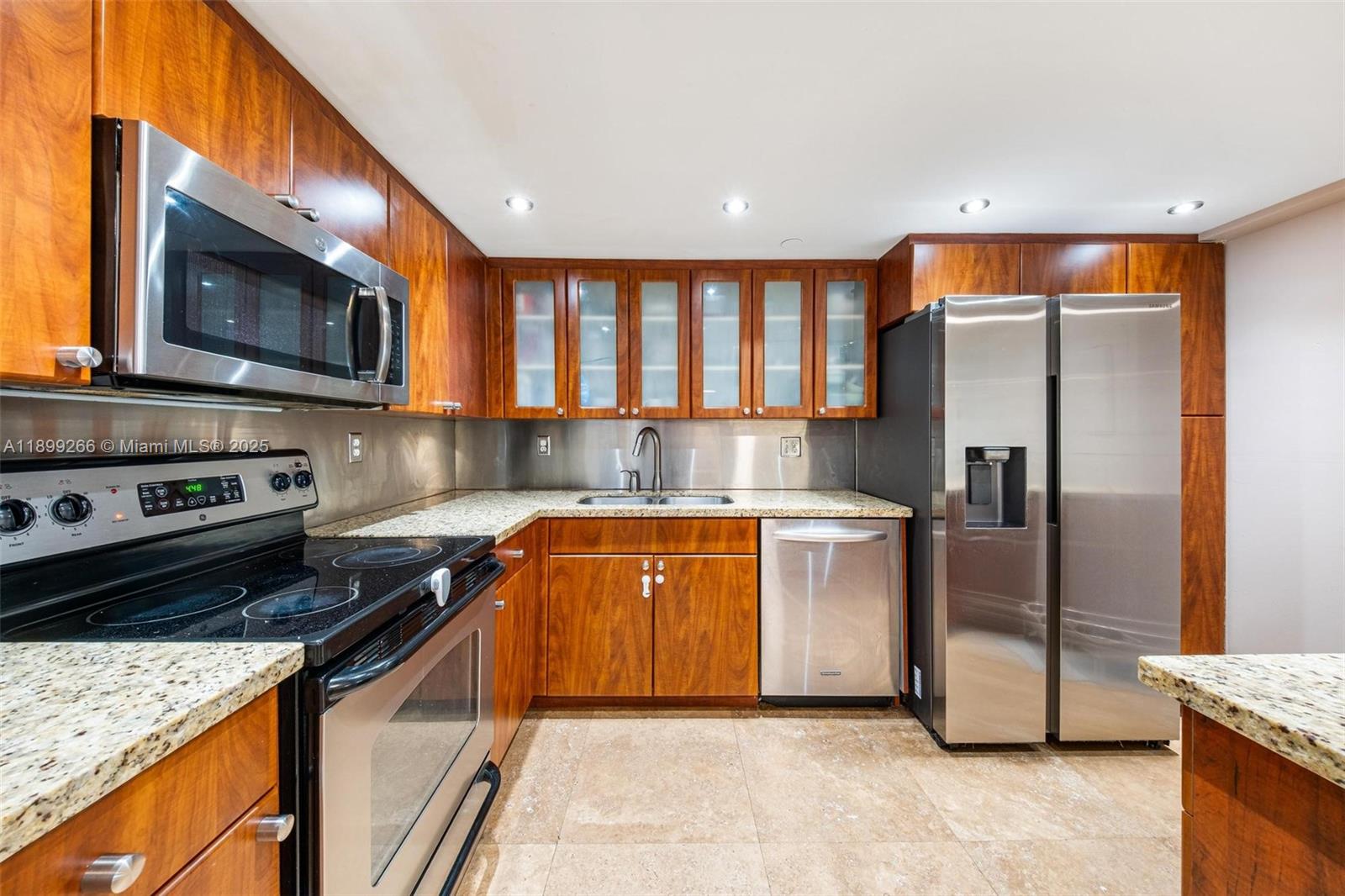 4000 Towerside Terrace, Unit 604 Miami, FL 33138 - Photo 13 of 79 a kitchen with stainless steel appliances granite countertop a refrigerator a stove a sink and a microwave
