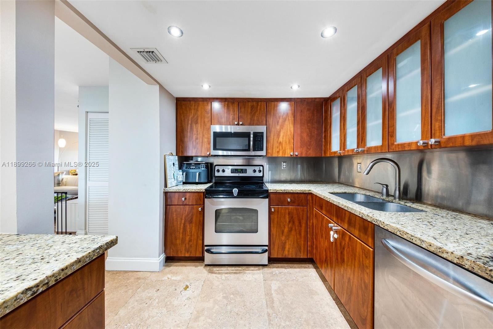4000 Towerside Terrace, Unit 604 Miami, FL 33138 - Photo 14 of 79 a kitchen with stainless steel appliances granite countertop a sink stove microwave and refrigerator