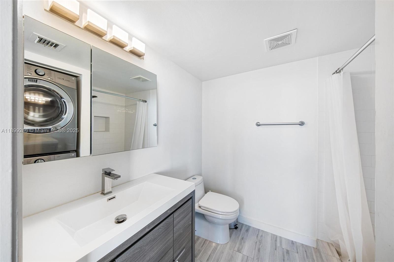 4000 Towerside Terrace, Unit 604 Miami, FL 33138 - Photo 18 of 79 a bathroom with a sink a toilet and a mirror