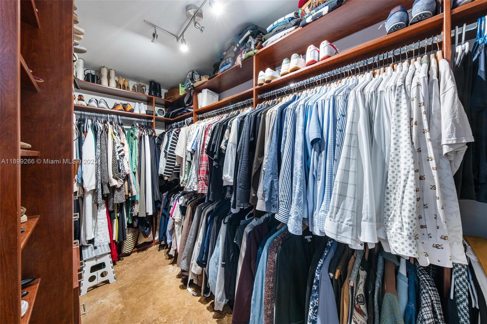 4000 Towerside Terrace, Unit 604 Miami, FL 33138 - Photo 23 of 79 a view of walk in closet with clothes and shoes