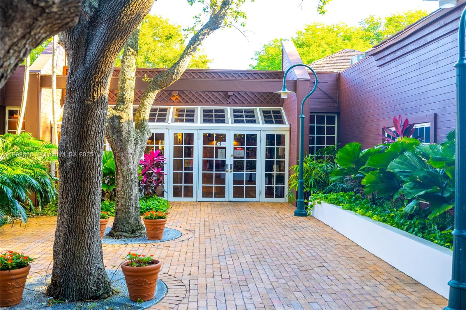 4000 Towerside Terrace, Unit 604 Miami, FL 33138 - Photo 73 of 79 a front view of a house with a yard and potted plants