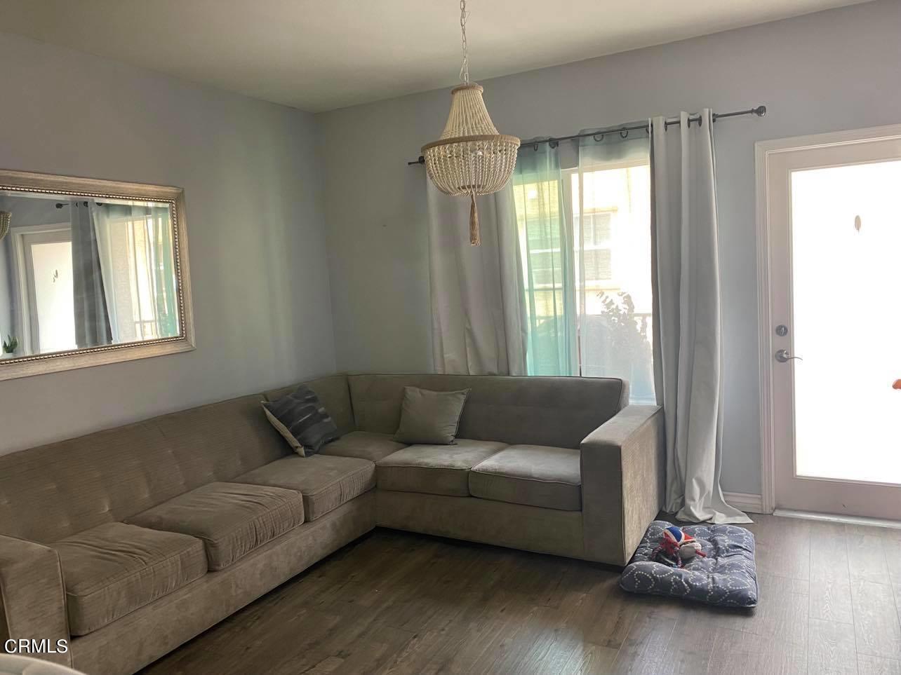 351 Riverpark Boulevard, Unit 202 Oxnard, CA 93036 - Photo 3 of 9 a living room with furniture and a window