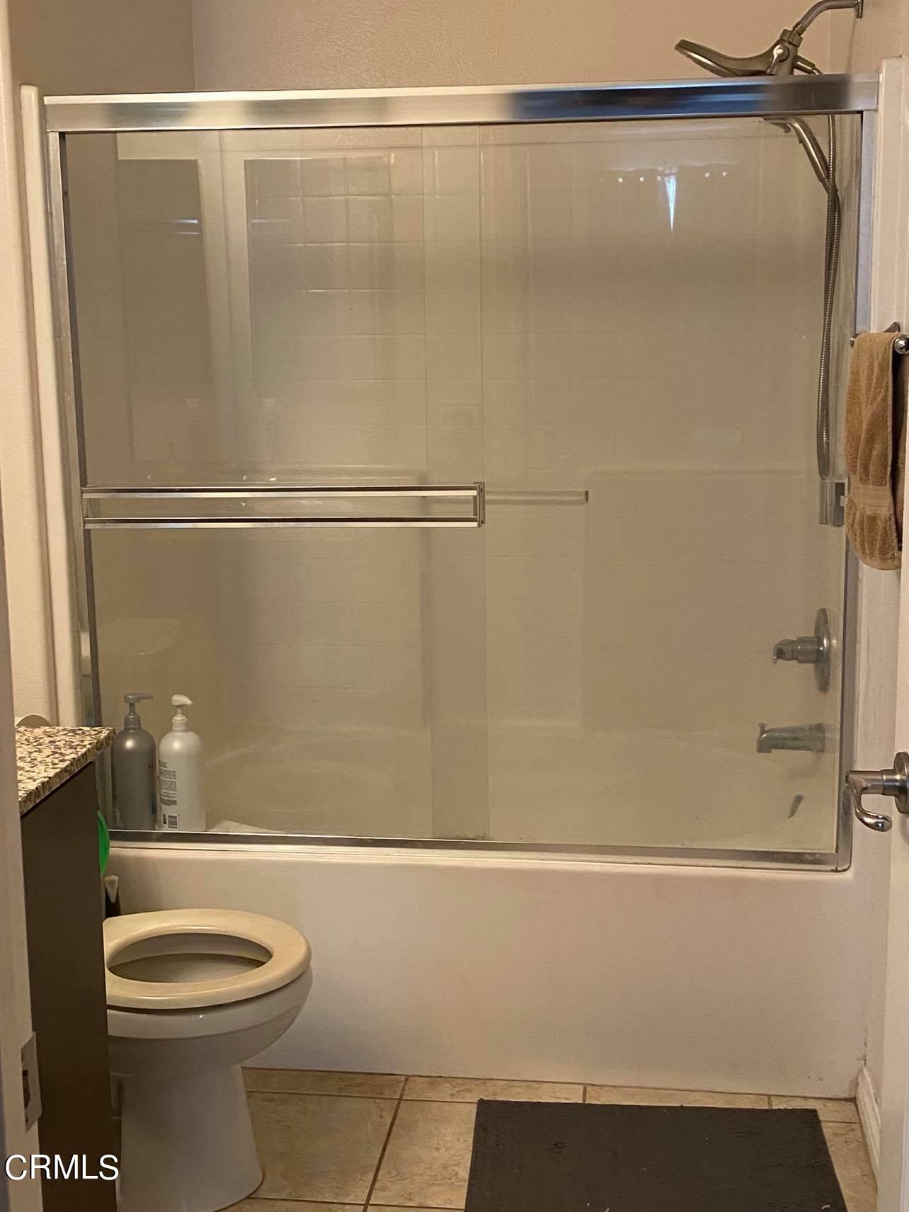 351 Riverpark Boulevard, Unit 202 Oxnard, CA 93036 - Photo 4 of 9 a bathroom with a shower and a toilet